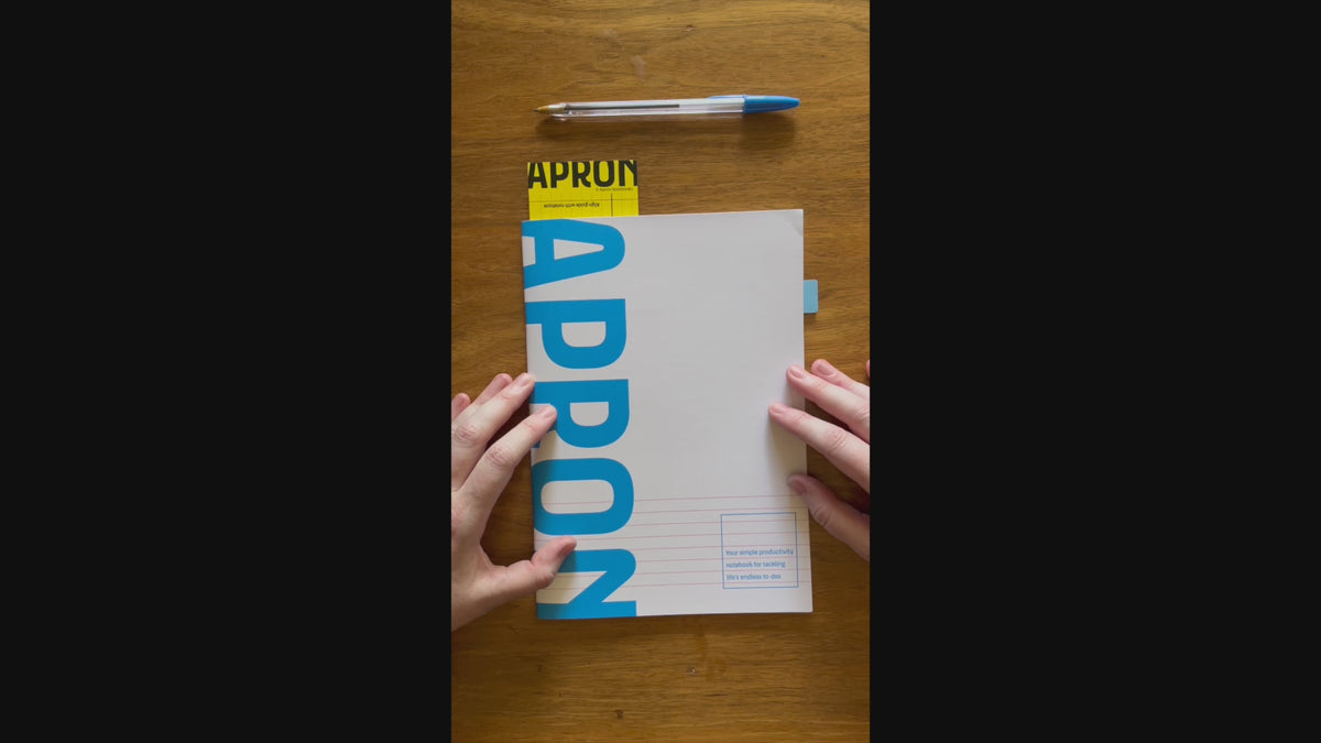 Load video: A video of a woman using the APRON notebook
